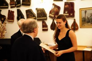 Tamara Niekludow receives diploma and gifts .